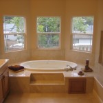 Master Bath tub sits in a bay window with a fireplace